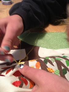 Attaching the leaves using embroidery floss.